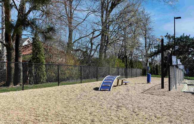 A playground with a slide and a fence.