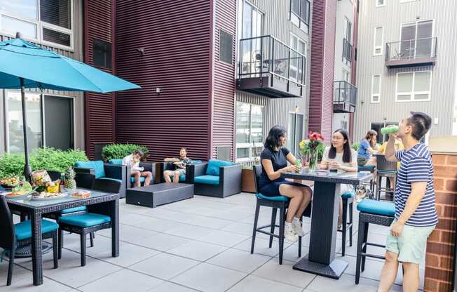 a group of people sitting at a table on a patio