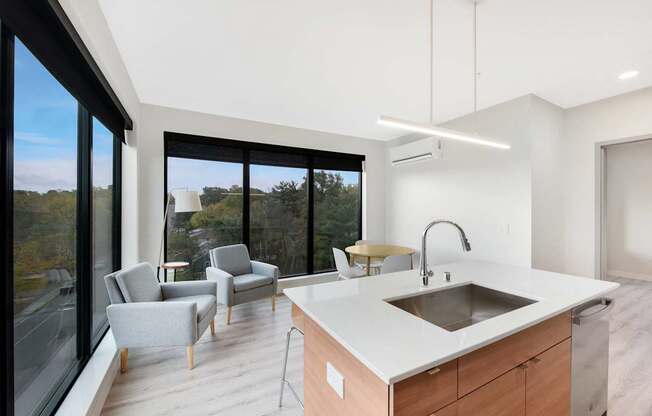 A modern kitchen with a large island and a view of the outdoors.