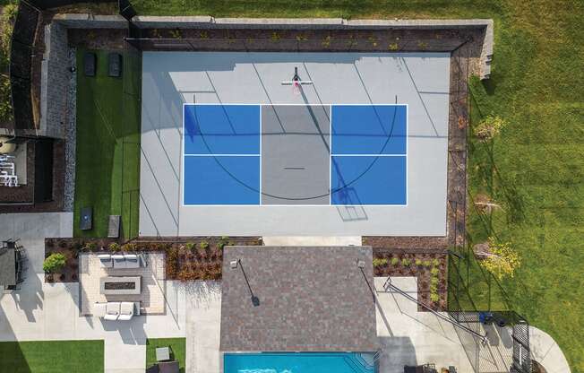 a backyard court with a basketball court and a pool