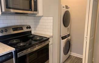 Stackable wash dryer next to kitchen at Triangle Park Apartments, North Carolina, 27713