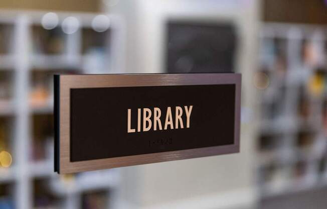 a sign for library with the word library on it