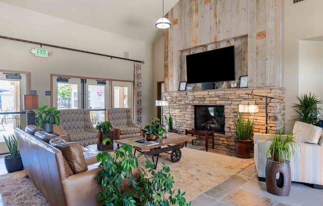 a living room with couches a coffee table and a fireplace