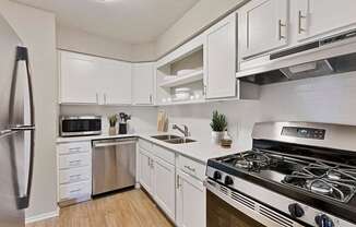 a kitchen with stainless steel appliances and white cabinets