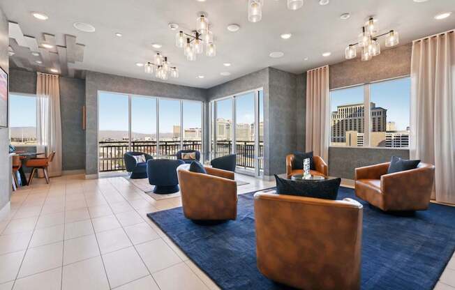 A spacious living room with a view of the cityscape outside the large windows.