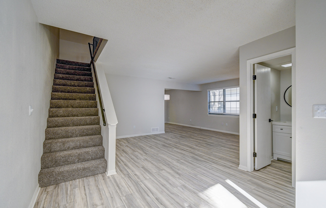 Carpeted staircase in townhome front entrance interior at The Arbor in Blue Springs, Missouri