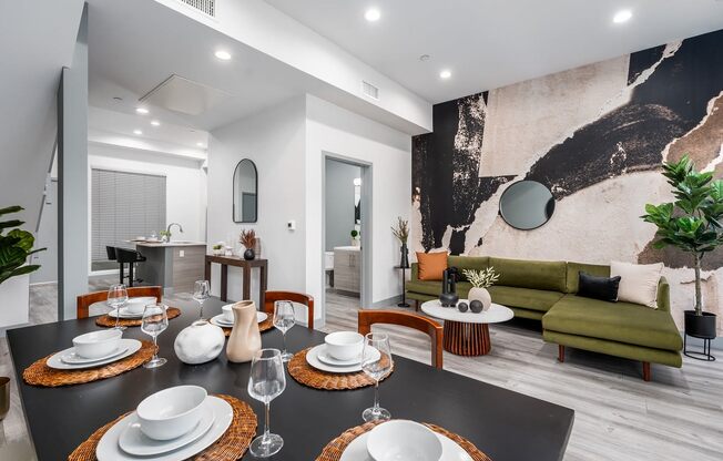 a dining room with a table and chairs and a living room