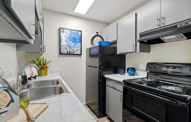 Kitchen with stainless steel appliances and a stove and refrigerator at Verde Apartments in Tucson, 85719