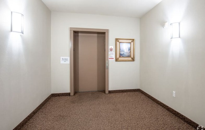 a room with a door to a closet and a carpeted floor