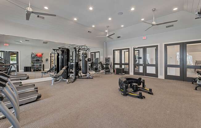A spacious gym with a variety of equipment including treadmills, weights, and exercise machines.