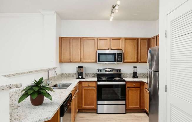 A kitchen with wooden cabinets and stainless steel appliances.