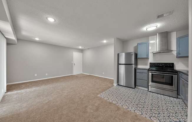 the kitchen and living room in a new home with stainless steel appliances