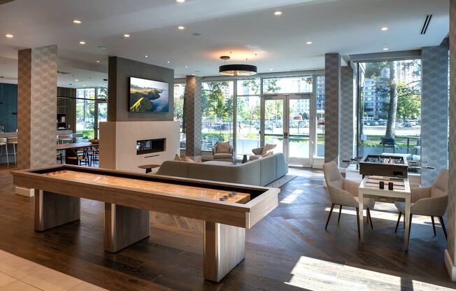 a living room with a pool table and a dining room at Sinclaire on Seminary, Alexandria