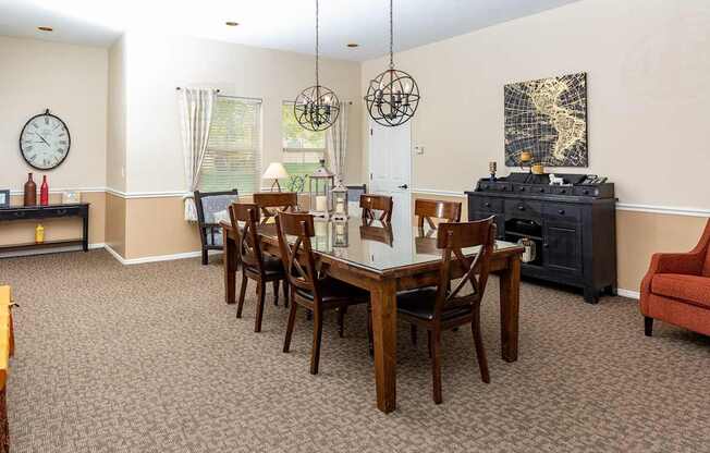 A dining room with a wooden table and chairs.