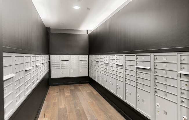 a bunch of mailboxes in a room with wooden floors