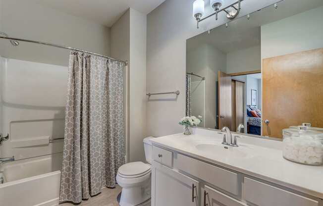 a bathroom with a shower and a sink and a toilet