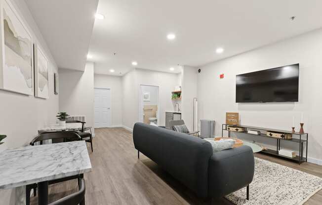 a living room with a couch and a tv  at Switchback on Platte Apartments, Littleton, Colorado