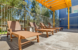 A sunny day at the outdoor seating area with wooden benches and tables.