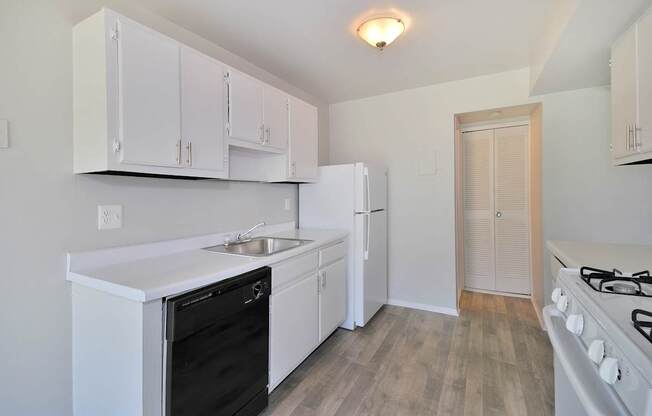 “Fully equipped apartment kitchen with modern appliances at Farmbrooke Manor Clinton Township MI