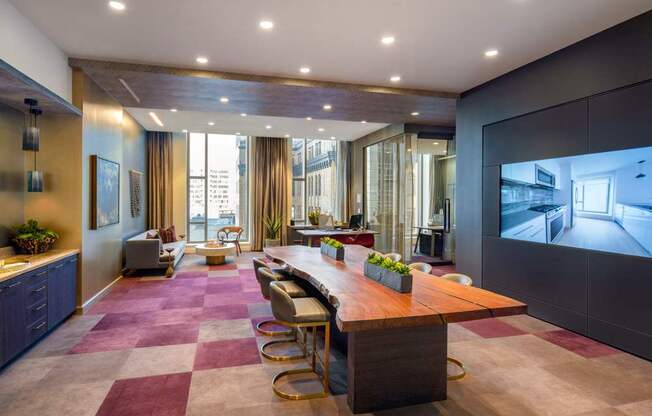 A conference room with a long table and chairs.