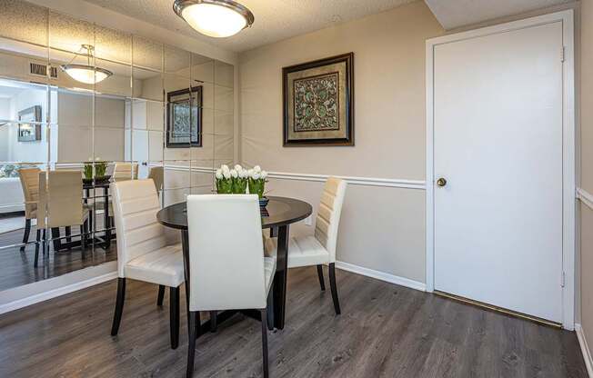 A dining room with a table and chairs.