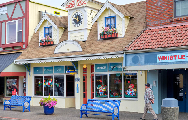 a man walking down the street in front of a store at Woodcreek, Poulsbo, WA