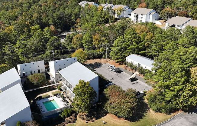 arial view of a house surrounded by trees and buildings