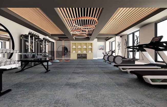 A gym with a variety of equipment including treadmills, weights, and exercise machines.