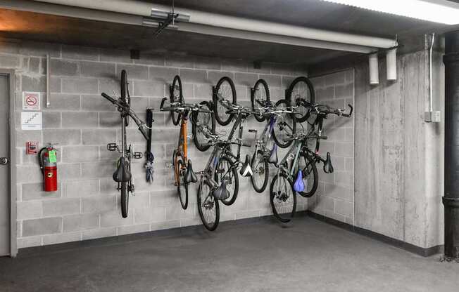 A bike rack with several bikes hanging on it.