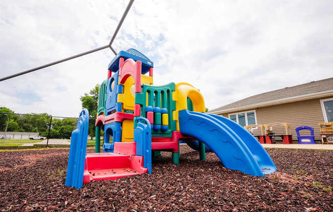 a multicolored play set in a yard at Sutton Hill Apartments, Des Moines, 50320