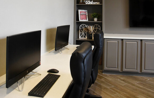 a computer desk with two monitors and a keyboard