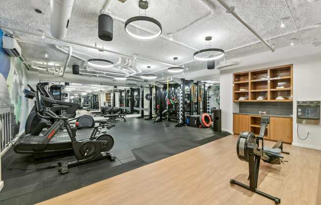 a gym with weights and other exercise equipment on a wooden floor  at Link Apartments® H Street, Washington, Washington