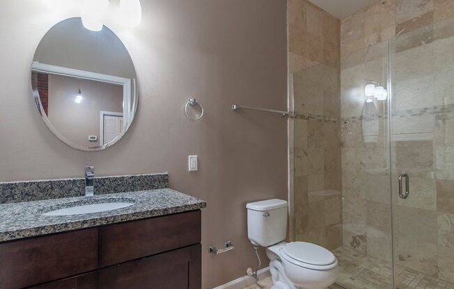 Bathroom with vanity and large shower with glass door
