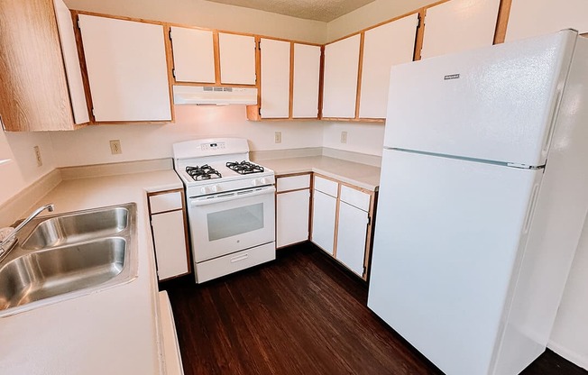 a kitchen with white appliances and white cabinets