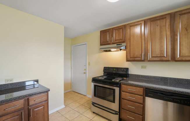 Spacious kitchen with stainless steel appliances and wood cabinets