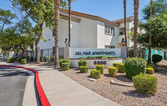 A building with a sign that says Delmar Apartments.