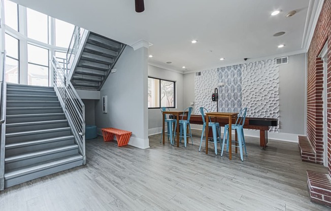 clubhouse lounge with a table and a staircase