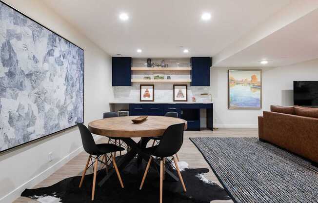 a living room and dining room with a table and chairs