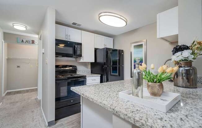 A kitchen with granite countertops and stainless steel appliances.