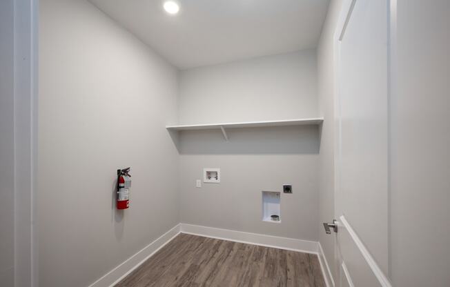 a small room with a fire extinguisher on the wall