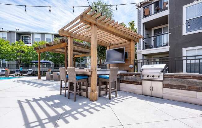Apartments for Rent in Napa - Montrachet - BBQ Area Next to Pool with Grill, Countertop, TV, and Stools