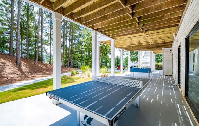 a ping pong table on the porch of a house