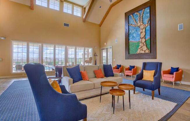 club house with couches and chairs to relax surrounded by windows in a big room
