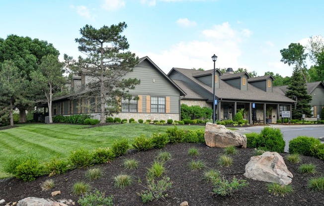 A large house with a landscaped front yard.