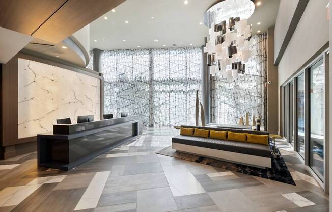 a lobby with a reception desk and a large glass door