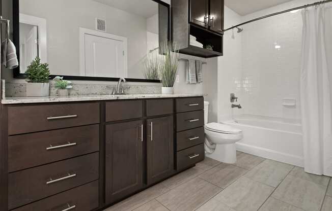 an image of a bathroom with wooden cabinets and a toilet
