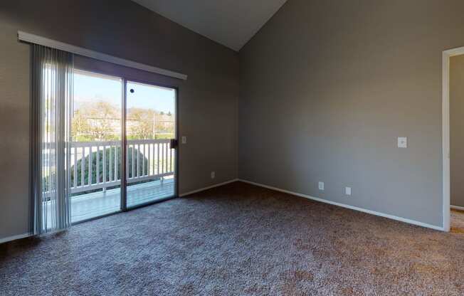 Two Bedroom Apartments in Ontario CA - Rancho Vista - Unfurnished Bedroom With Lush Carpet, a Sliding Glass Door With Shutters, and Balcony Access