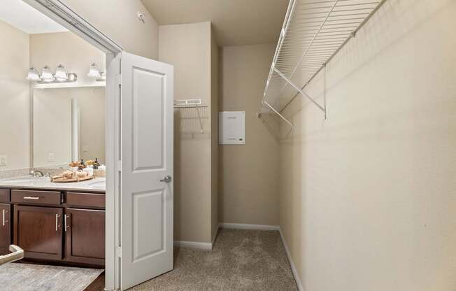 A kitchen with a white door is open to a hallway.