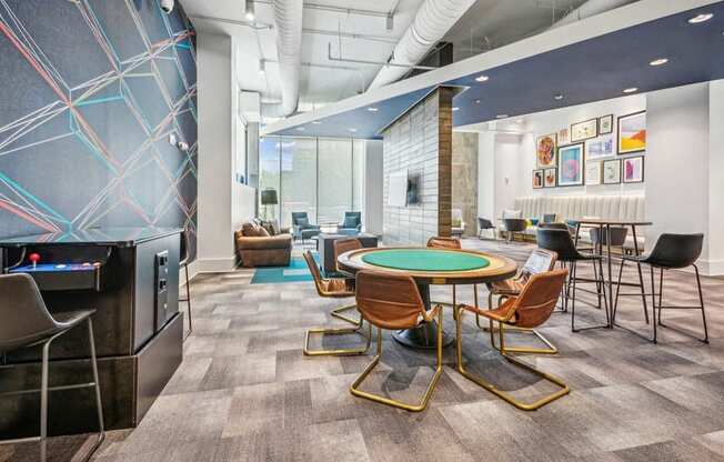 a room with a round table with chairs and a television at Link Apartments Innovation Quarter, North Carolina, 27101