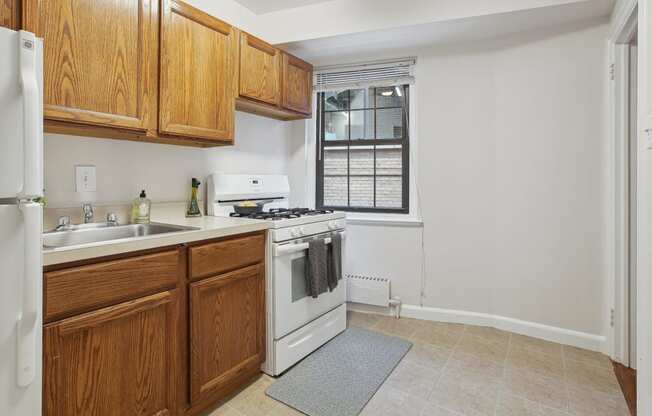 a kitchen with white appliances and wooden cabinets